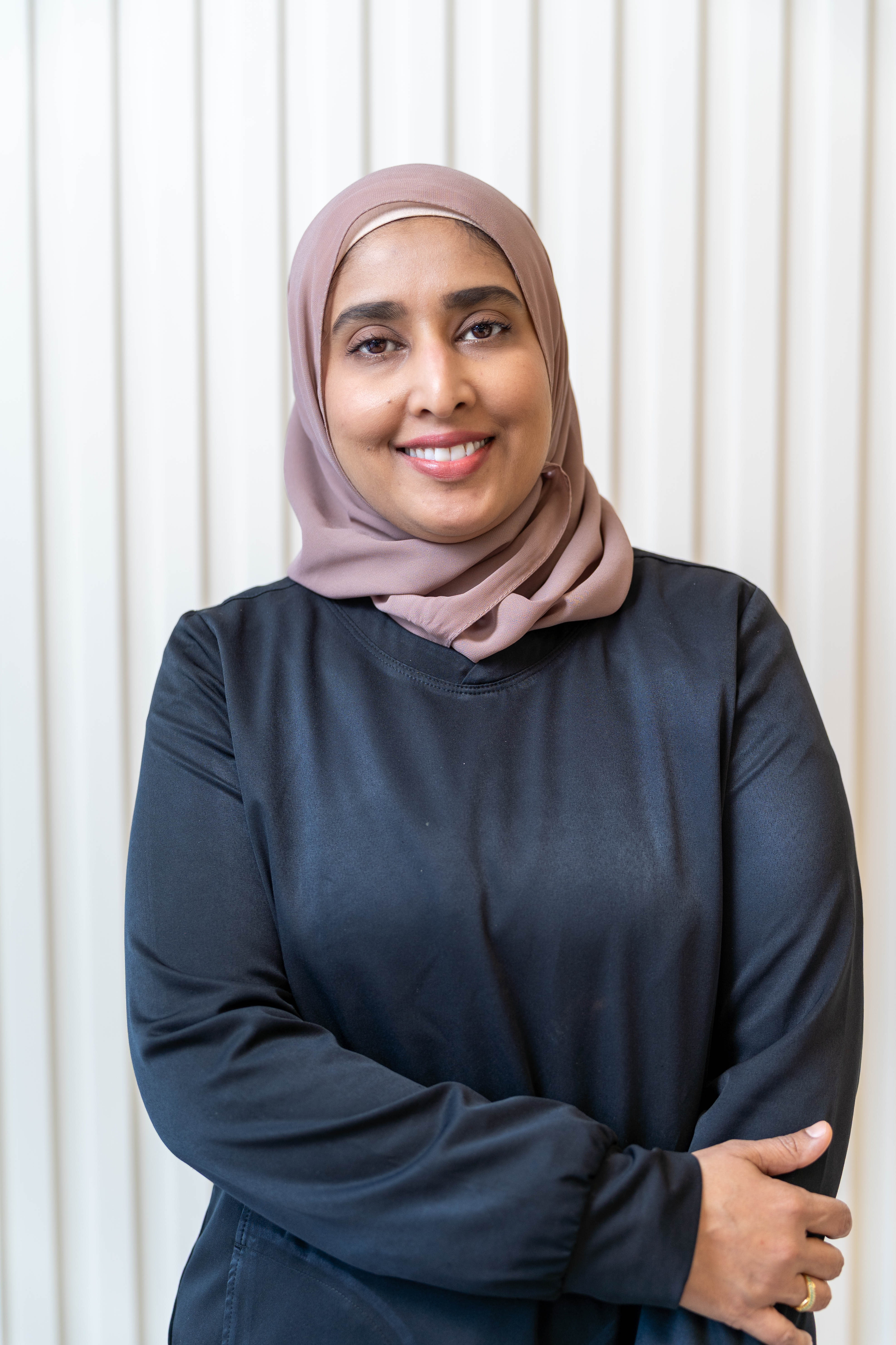Dr. Faiza smiling warmly at SmileHaven Dentistry